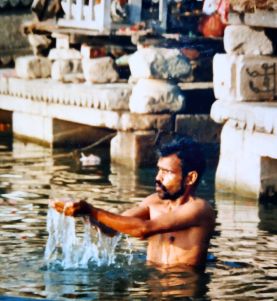 Catching a glimpse - man doing puja in Kashi
